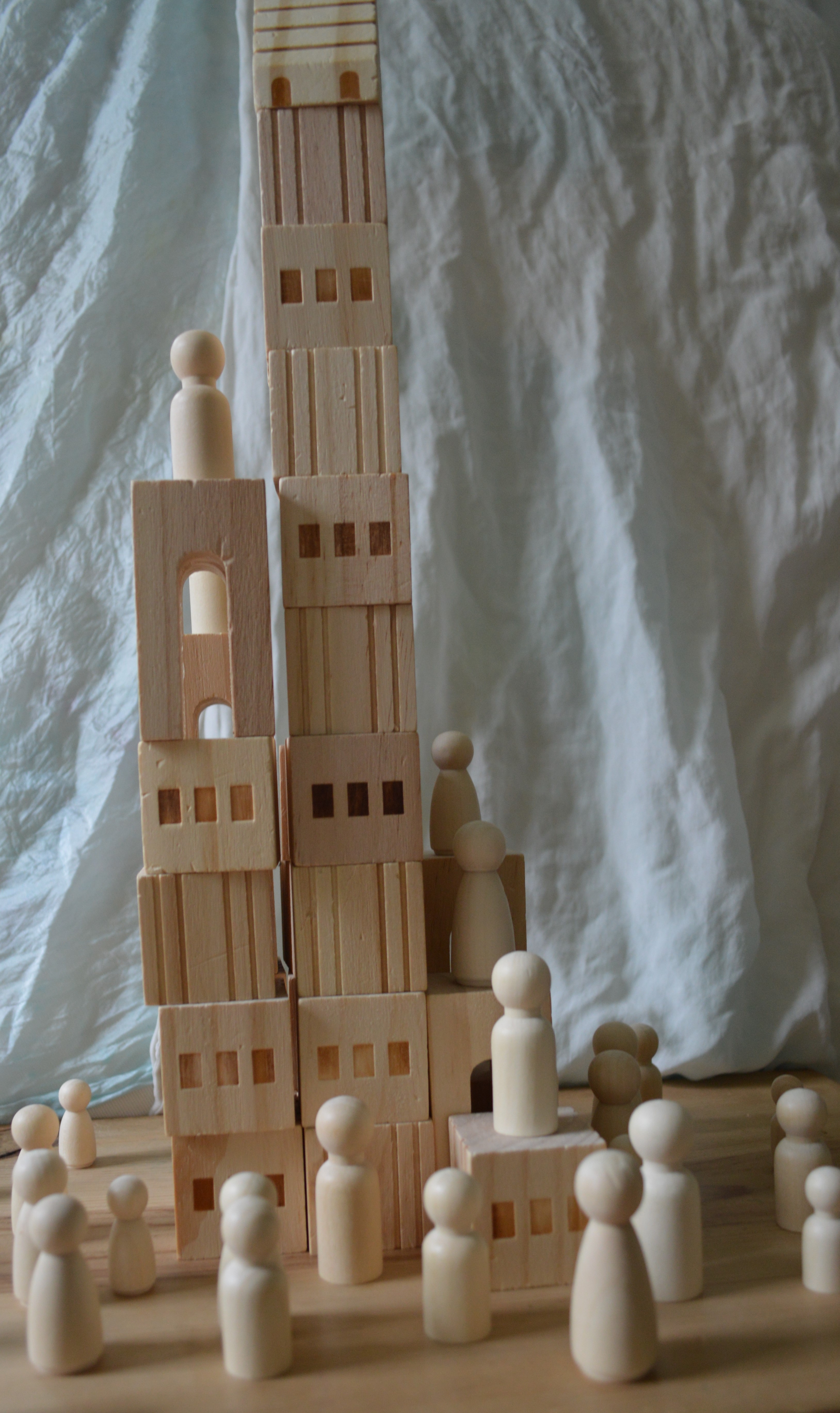 Peg dolls and blocks represent the tower of Babel being built.