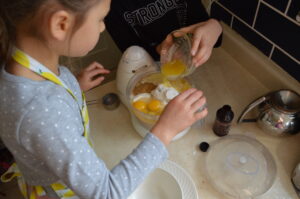 Cooking with Children- Two kids measure ingredients