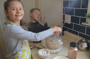 Cooking with Children- Two kids help with food processor