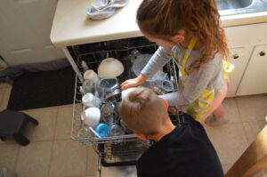 Cooking with Children- Two kids load the dishwasher