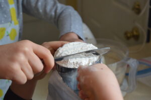 Cooking with Children- Two kids leaven flour
